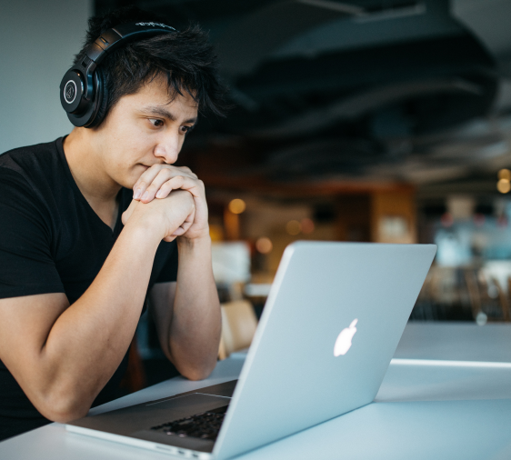 a overwhelmed man sitting in front of a laptop computer